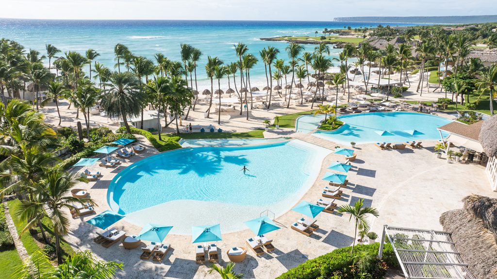 Aerial drone view of Eden Roc Cap Cana Beach Club in the Dominican Republic, showcasing the luxury oceanfront resort, Caribbean beach, infinity pool, white sand shoreline, and private estate residences. Real Living Productions serves as the Marketing Agency of Record, providing luxury real estate marketing, lead generation, branding, and digital marketing for Eden Roc Cap Cana.